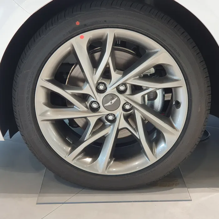 Hyper silver double five-spoke wheel on a white car in a showroom