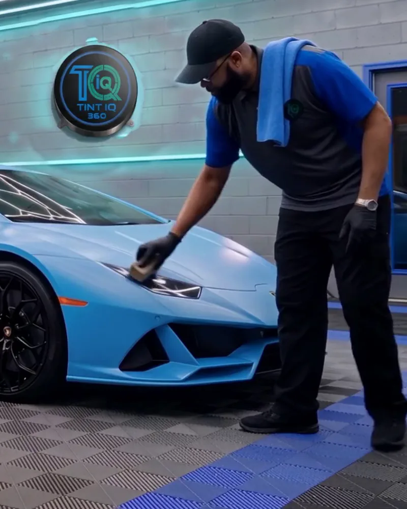 Jay wiping ceramic coating onto a blue Lamborghini Huracán with a suede applicator